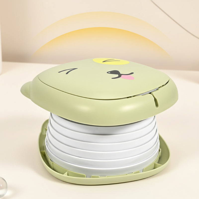Expanded green portable potty with its animal-face lid closed