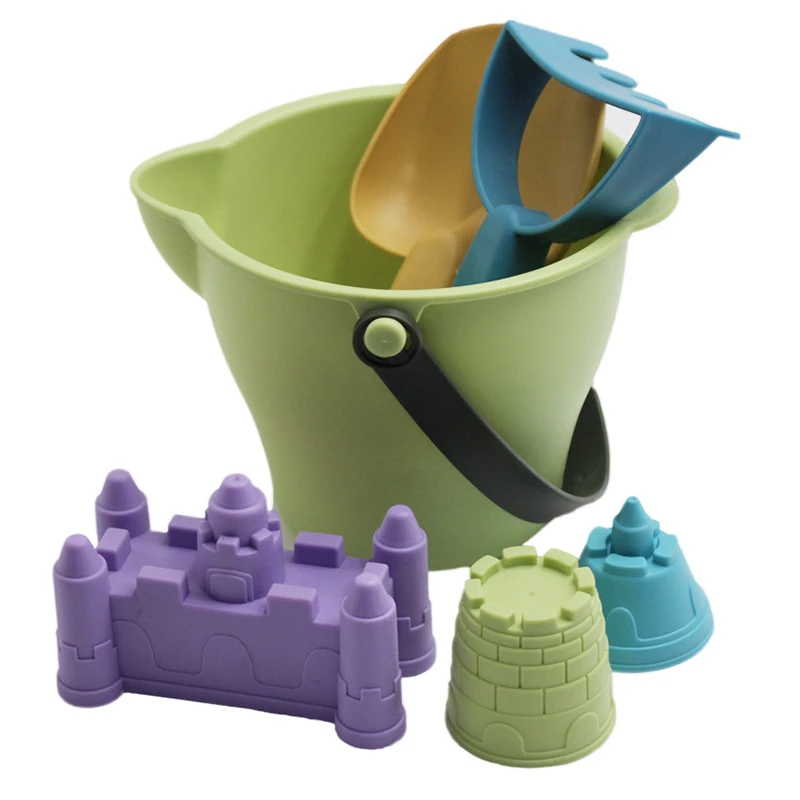 Green pouring bucket with a yellow scoop, blue rake, and castle and tower sand molds