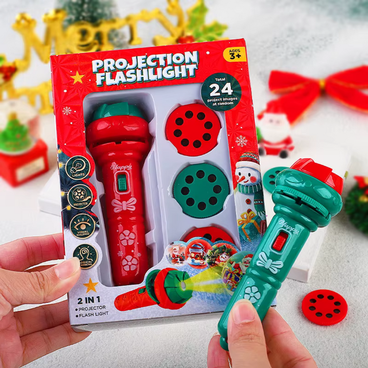 Green Christmas projection flashlight held beside its packaging and a red picture disc