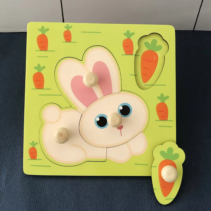 Green rabbit peg puzzle board with rounded wooden knobs and a loose carrot piece