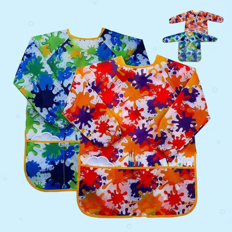 Green and red splatter-print kids' paint aprons with long sleeves and front pockets