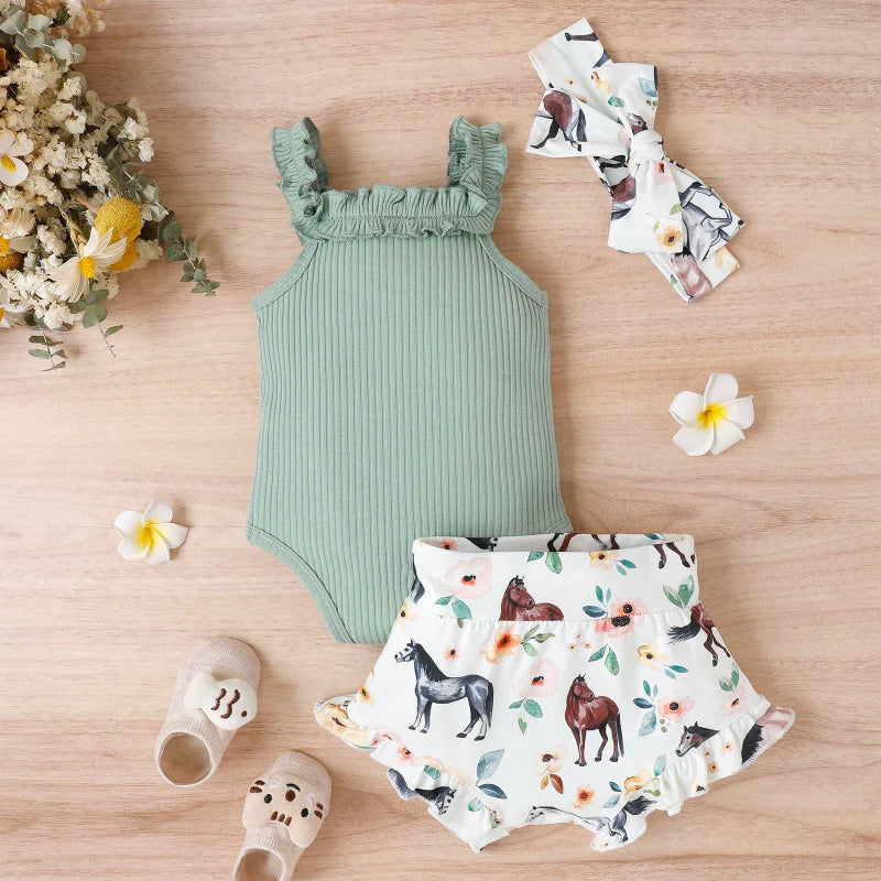Green ruffle-strap romper beside printed shorts and a coordinating headband