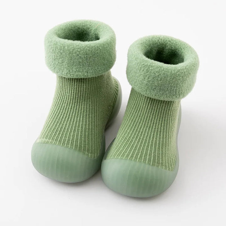 Green sock shoes with ribbed uppers, soft folded cuffs, and matching rubber soles.