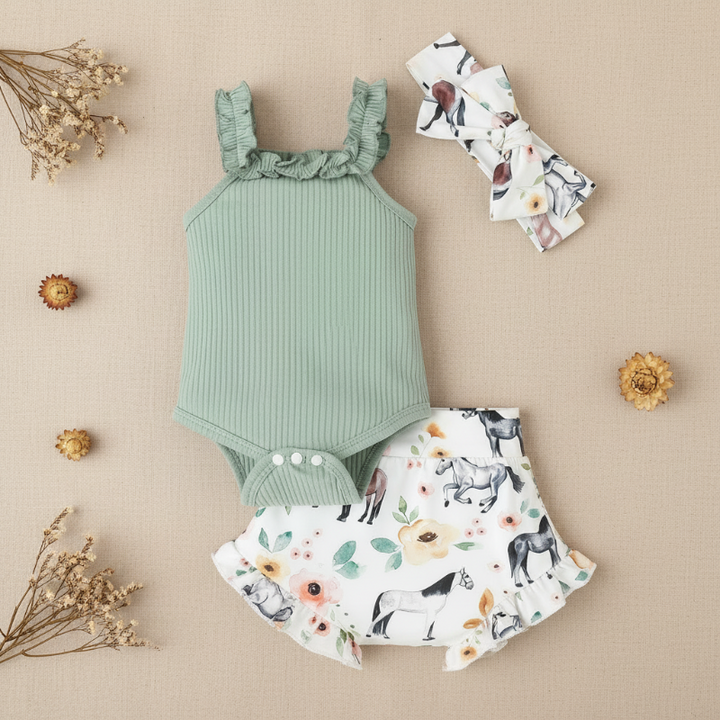 Green three-piece baby outfit with ribbed romper, animal-print shorts and bow headband