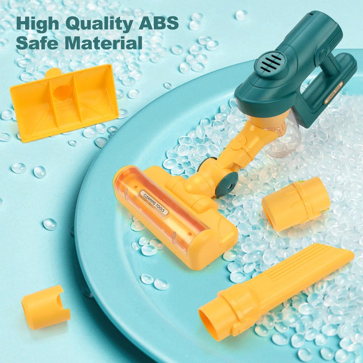 Green ABS toy vacuum with yellow attachments and extension pieces arranged on a blue background