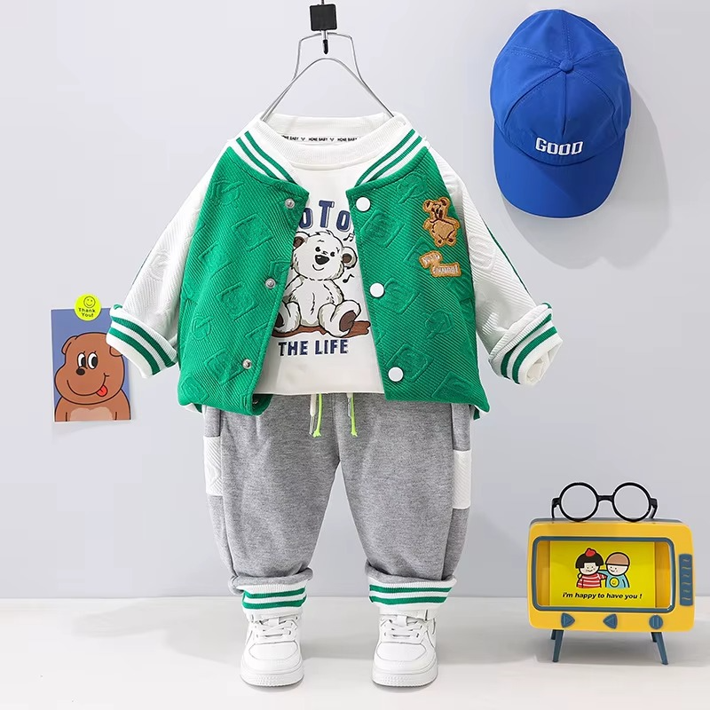 Green-and-white varsity jacket with a graphic T-shirt and gray joggers