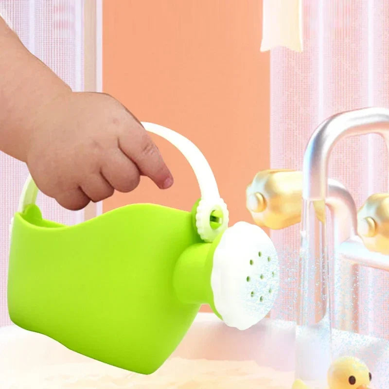 Green watering can with a white handle and sprinkler spout beside a faucet