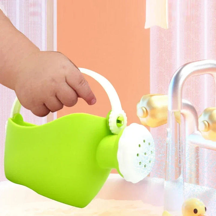 Green watering can with a white handle and sprinkler spout beside a faucet