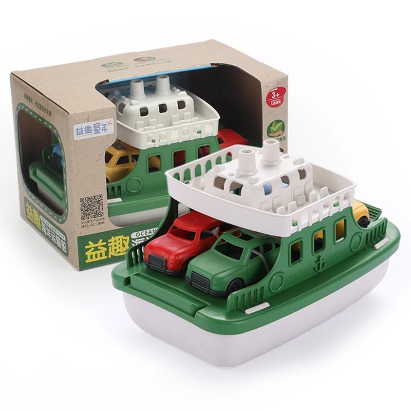 Green and white toy ferry with cars beside its display box