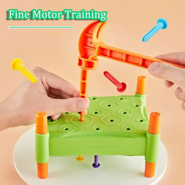 Hands positioning a peg and hammer above a green board with pegs extending underneath
