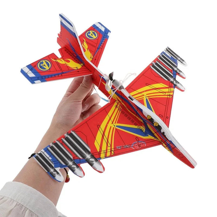 Hand holding a red and yellow foam airplane with angular wings