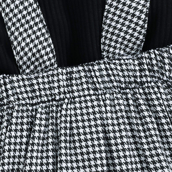 Close-up of the black-and-white houndstooth straps, waistband, and skirt pleats.