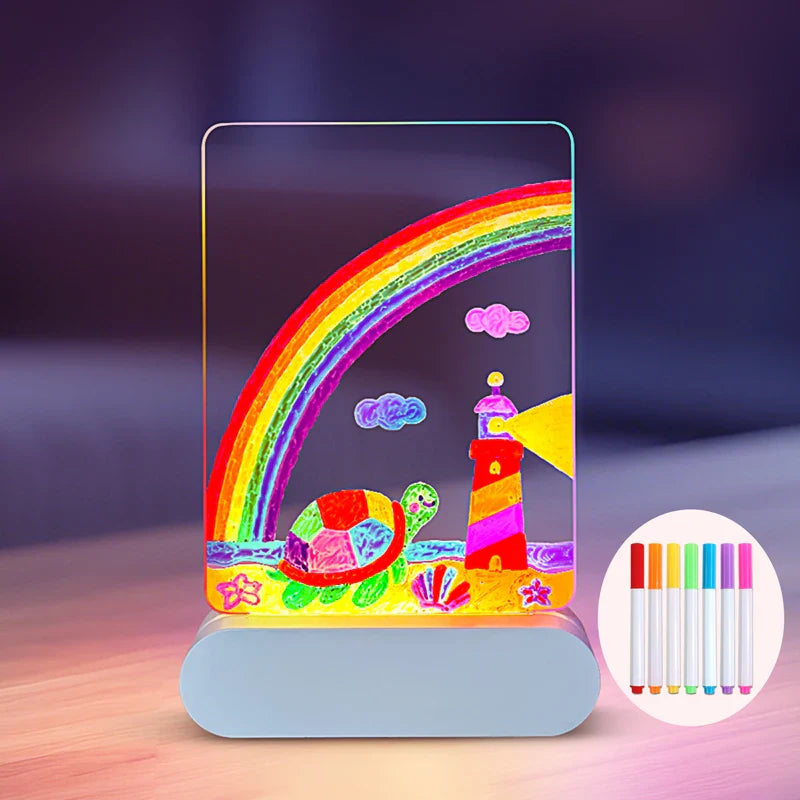 Illuminated drawing board with rainbow, turtle, and lighthouse artwork and a drawing pen inset