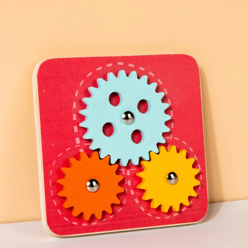 Wooden gear activity board with one large blue gear and two smaller orange and yellow gears.