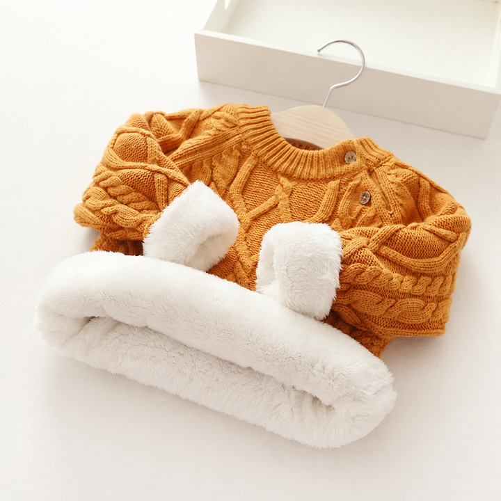 Khaki cable-knit sweater with plush white lining exposed at the hem and cuffs.