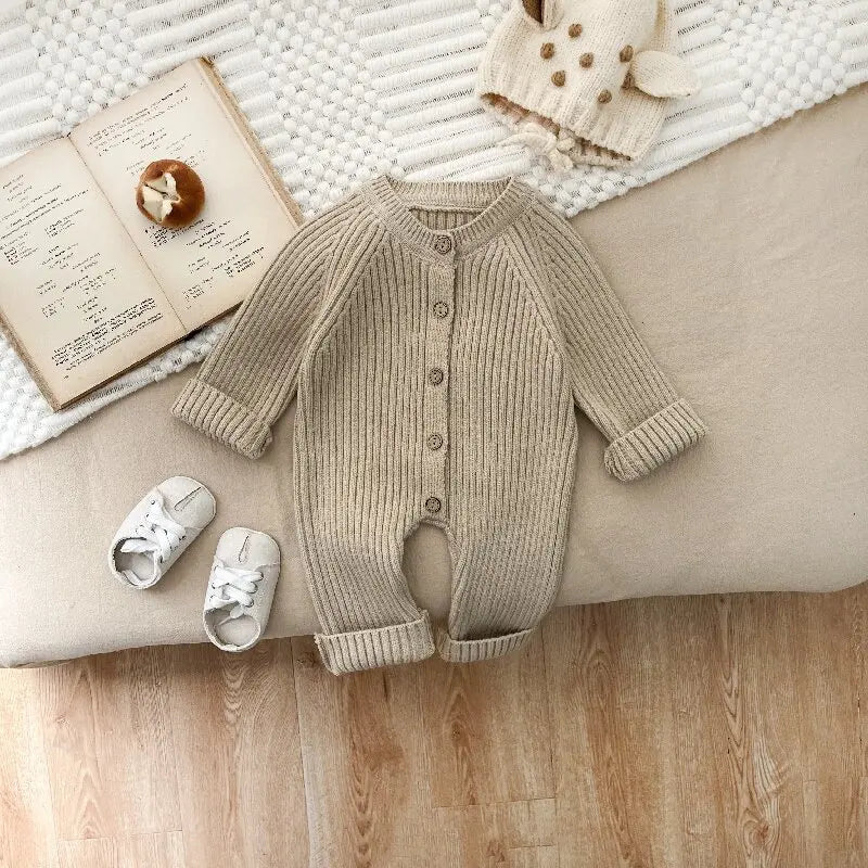 Khaki ribbed baby romper laid flat with long sleeves and a button closure