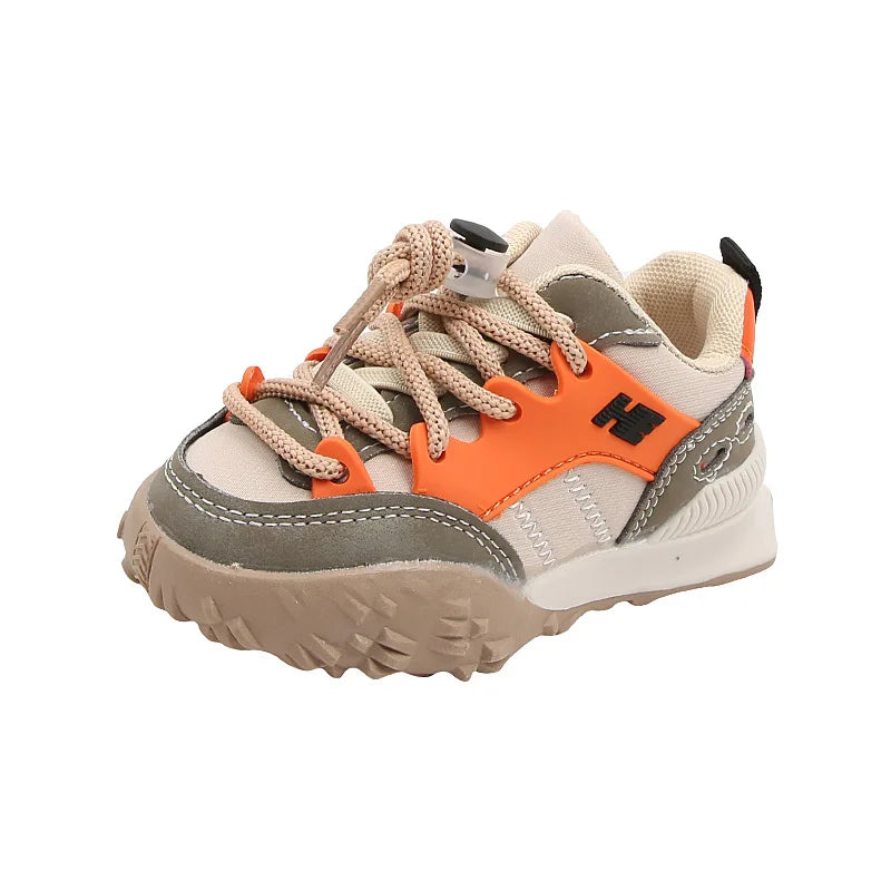 Khaki kids' sneaker with orange side panels, gray trim, laces, and a textured sole
