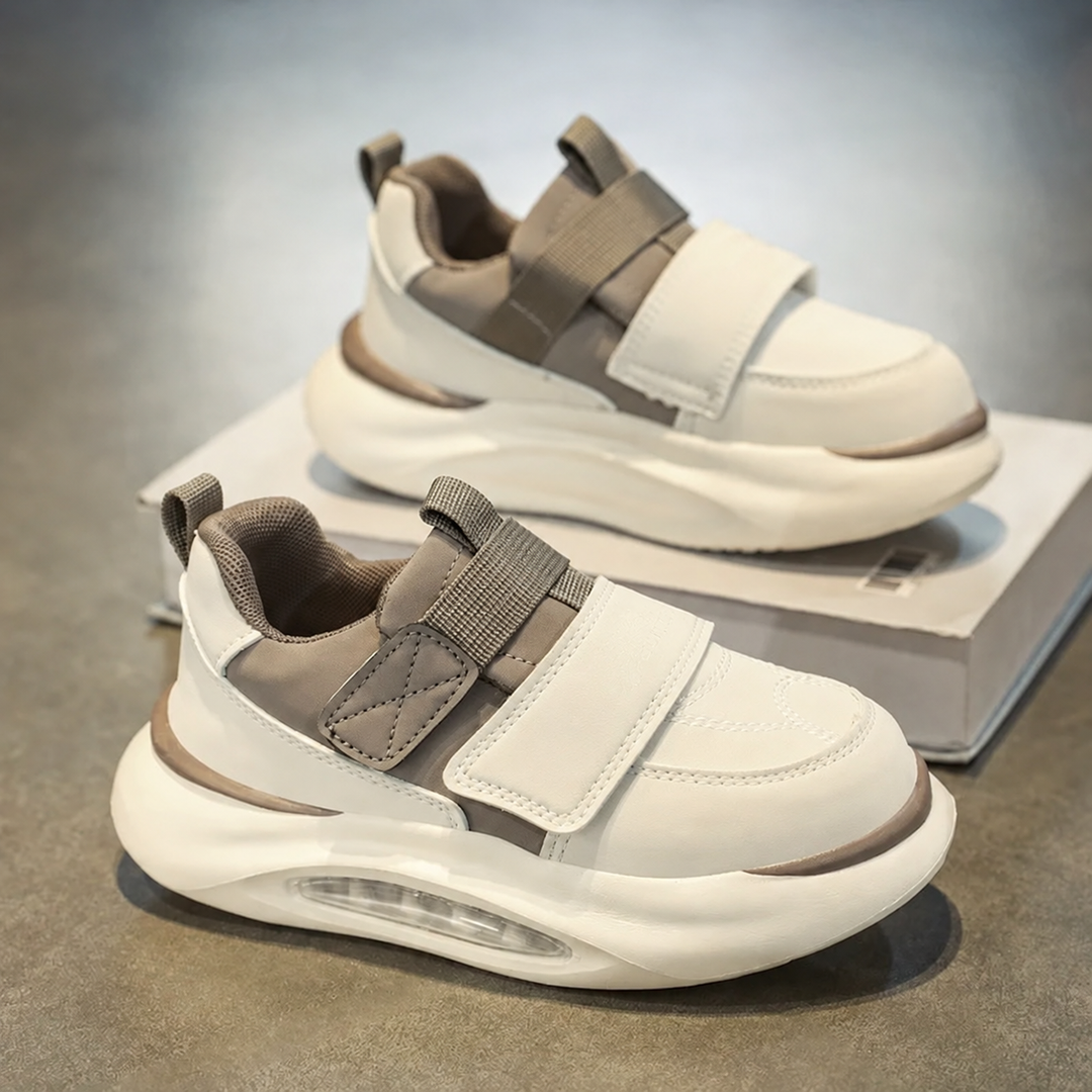 Side view of khaki and white sneakers with adjustable straps and chunky soles