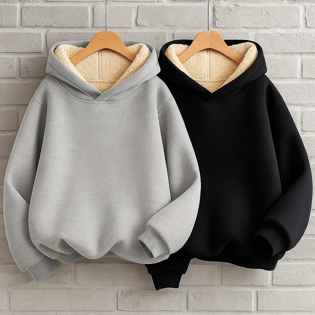 Gray and black kids' pullover hoodies on hangers, with cream fleece lining visible inside the hoods