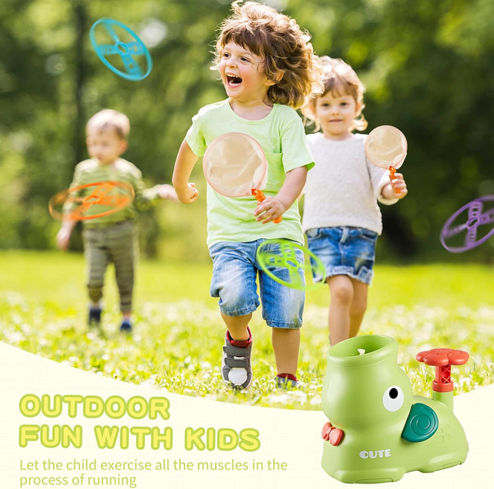 Children running on grass with catching nets beside a green flying-disc launcher