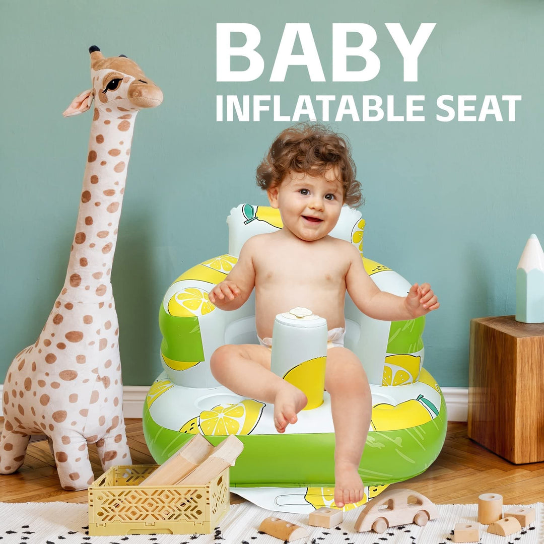 Child sitting in a lemon-print inflatable seat in a playroom with a giraffe decoration.