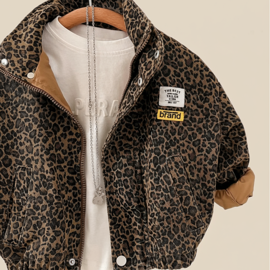 Brown leopard print kids' jacket on a hanger, styled with a white shirt and turned-up cuffs