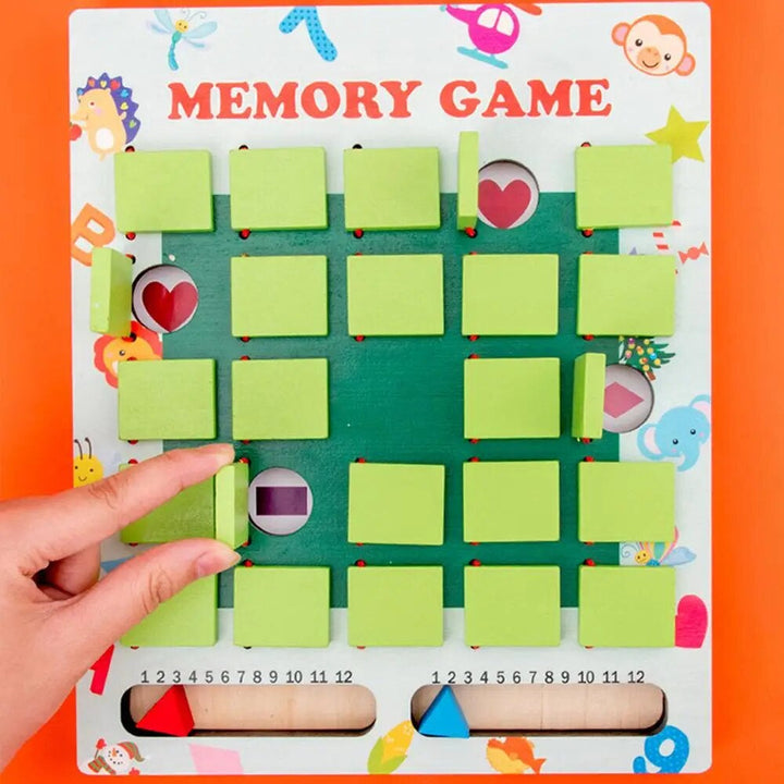 Fingers lifting a green cover to reveal a picture on the memory game board.