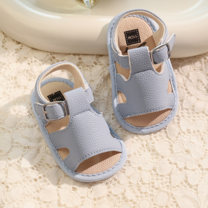 Light blue baby buckle sandals with open toes and side cutouts