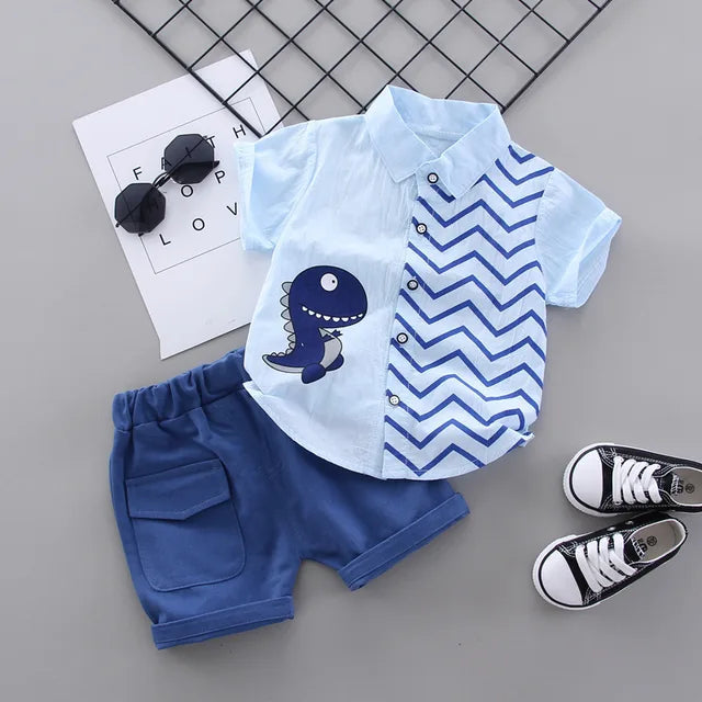 Light blue dinosaur shirt and blue shorts with an elastic waistband