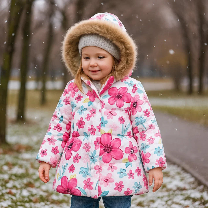 Child wearing a light blue winter coat with pink flowers and fluffy hood trim outdoors