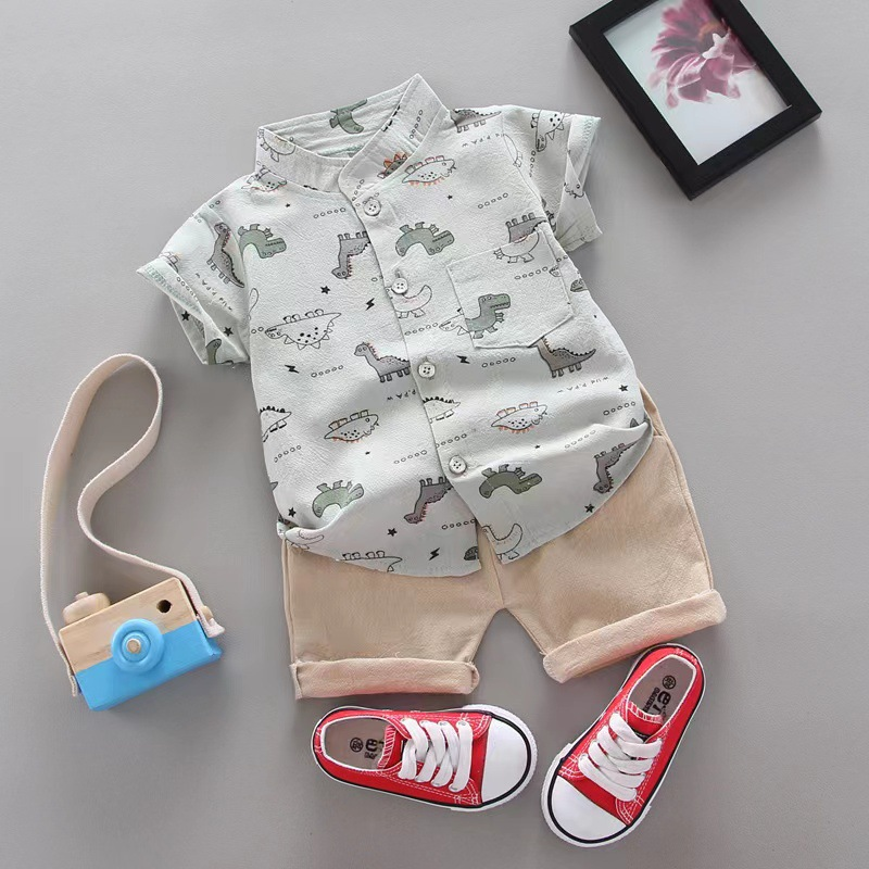 Light-colored dinosaur-print shirt paired with beige cuffed shorts