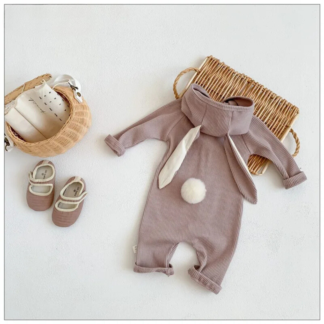 Light gray baby romper laid flat, showing long bunny ears and a round white tail