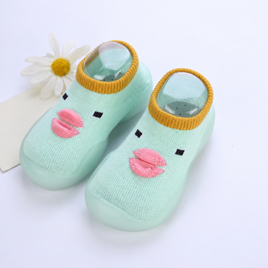 Light green duck-face sock shoes with pink beaks and mustard-colored cuffs