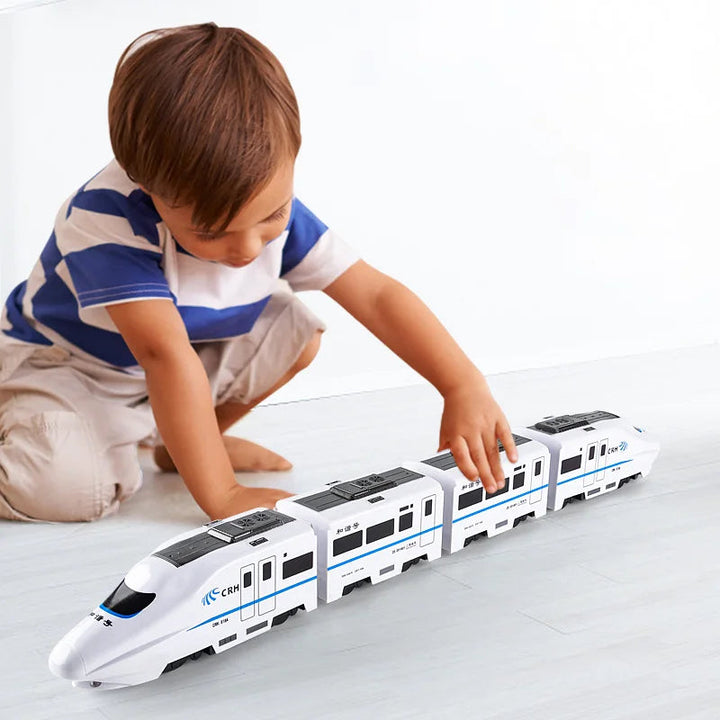 Child playing with a long, linked white and blue toy train