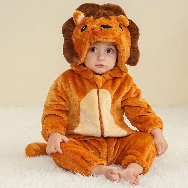 Baby seated in a golden-brown lion onesie with a mane hood and cream belly