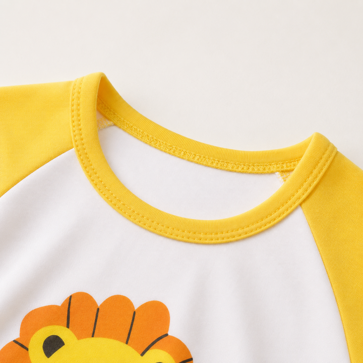Close-up of the yellow crew neckline on the white lion-print shirt.