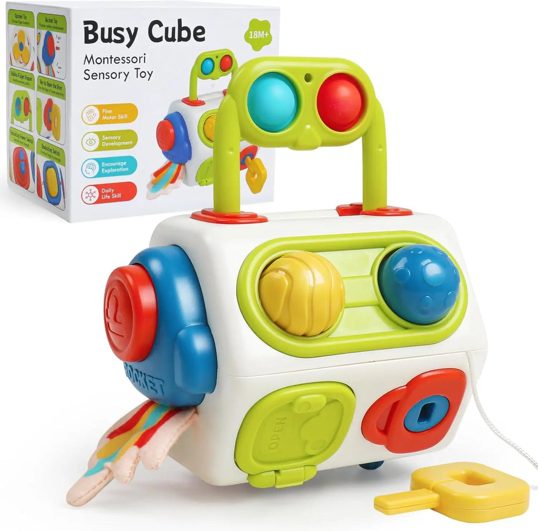Multicolor activity cube with buttons, a top handle, a yellow key, fabric tabs, and a retail box