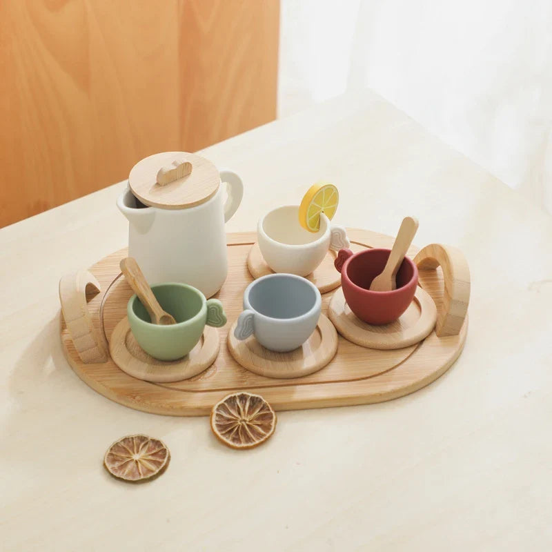 Wood and silicone toy tea set with four cups arranged on an oval wooden tray