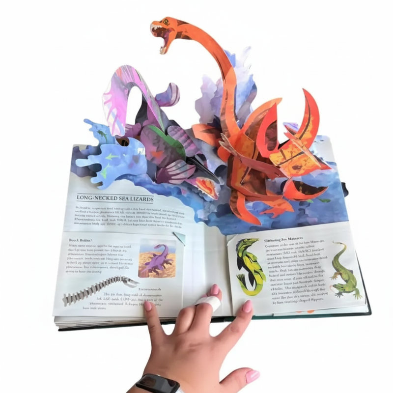 Sea monster pop-up scene with long-necked marine creatures, blue waves, and illustrated text panels