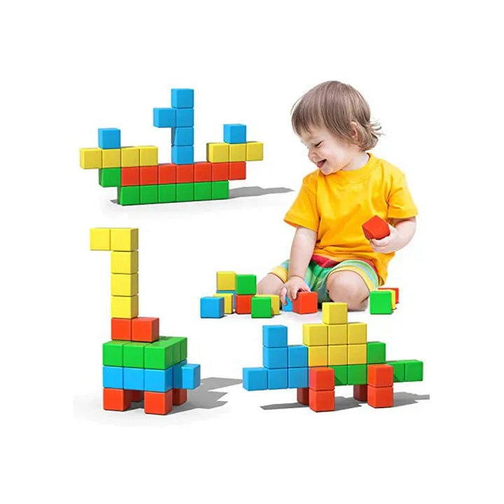 Child building with colorful magnetic cubes beside a boat and animal-shaped models