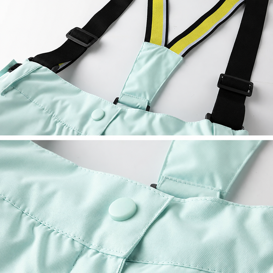Close-up of mint green ski pants showing adjustable suspenders and a snap-button waist