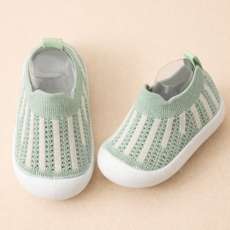 Mint green mesh sneakers with white vertical stripes and white soles.