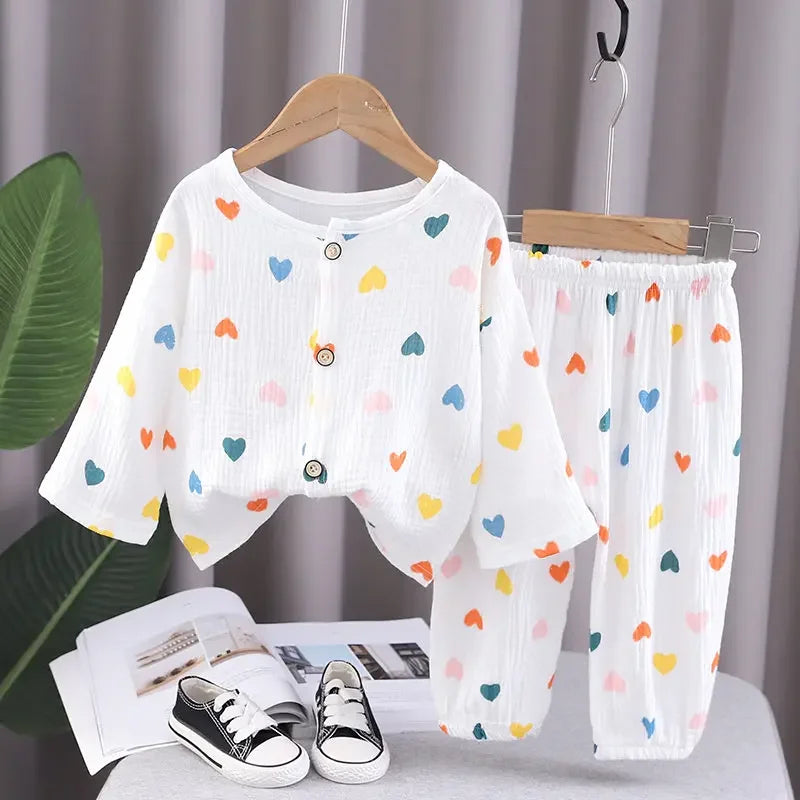 White pajama top and pants covered in small colorful hearts