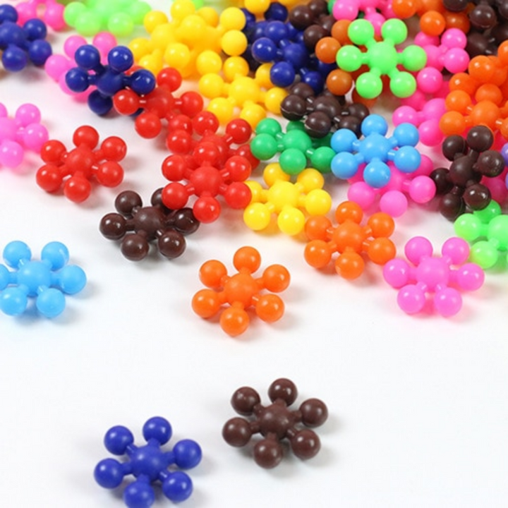 Loose snowflake-shaped building blocks in bright assorted colors