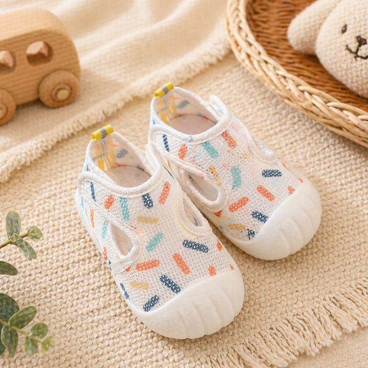 White baby strap shoes with colorful sprinkle prints and white toe caps.