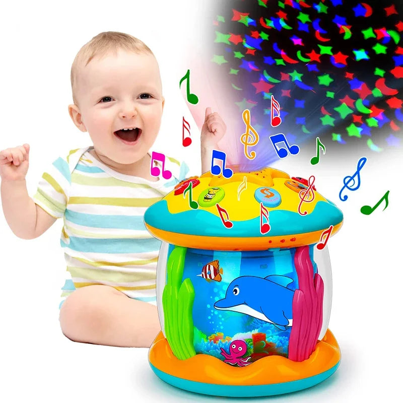 Baby beside a colorful musical aquarium toy with projection and music-note graphics