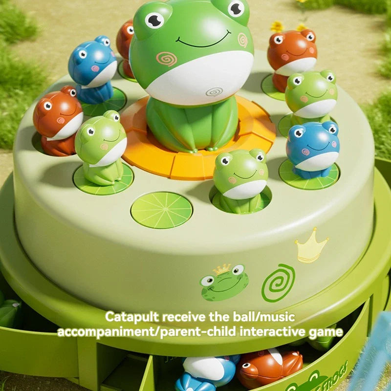 Close-up of colorful frog pieces arranged around the large center frog on the musical game