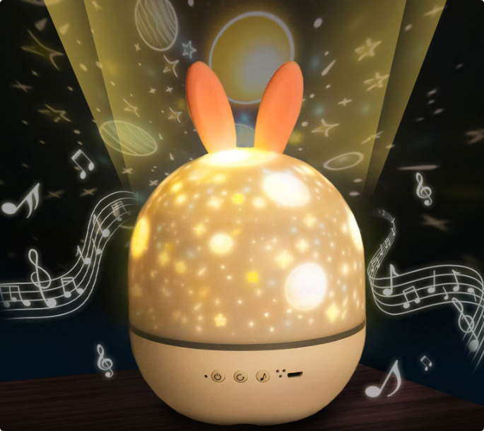 Bunny-ear projector with warm planet and star projections and illustrated music notes