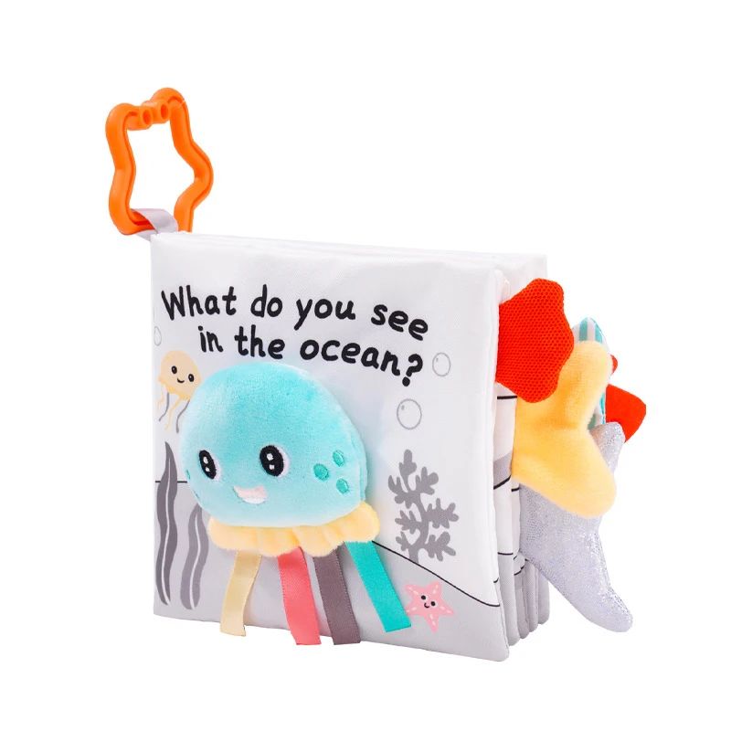 Ocean fabric book with a soft jellyfish cover, ribbon tentacles and an orange star-shaped clip