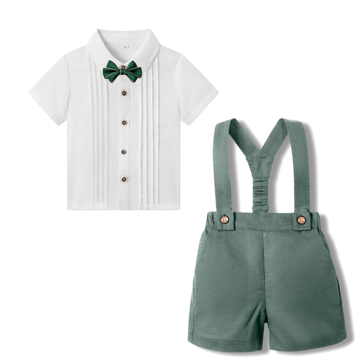 Olive green suspender shorts with a white short-sleeve shirt and green bow tie